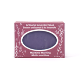 A mottled purple bar of soap in a rose coloured box with white line drawings of lavender sprigs and flowers. Text reads Artisanal Lavender Soap (Maritime Morning)