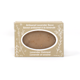 A taupe bar of soap in a sand coloured box with white line drawings of lavender sprigs and flowers. Text reads Artisanal Lavender Soap (Lavender Oatmeal)